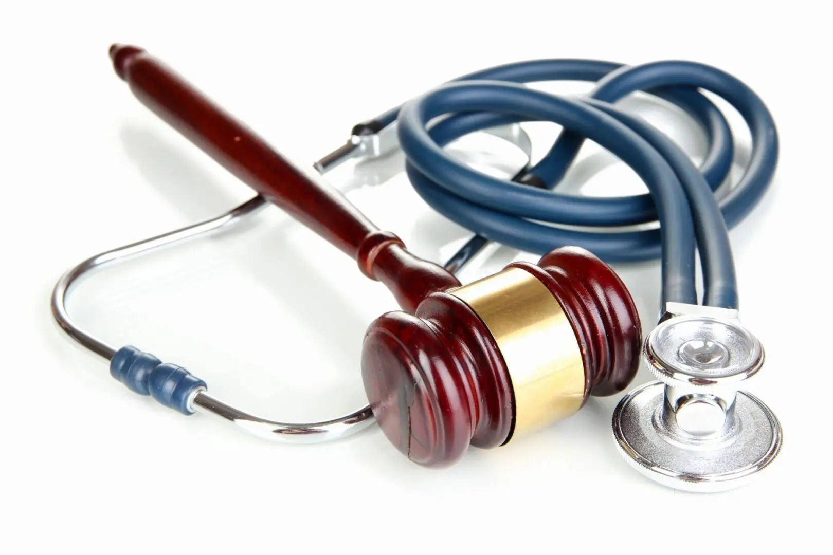 A judge 's gavel and stethoscope on top of the table.