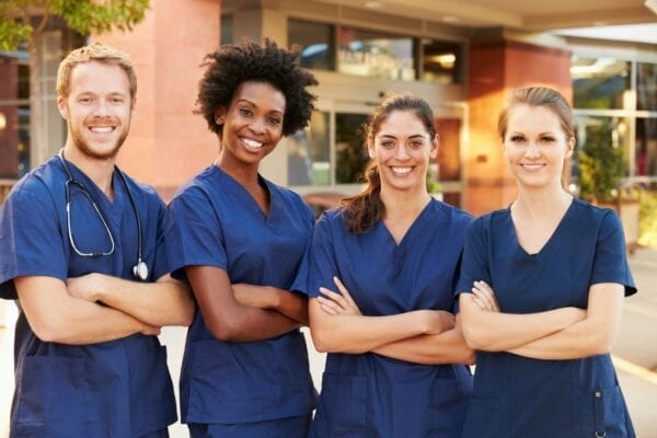 A group of nurses standing next to each other.