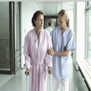 Two women in scrubs are walking down a hallway.