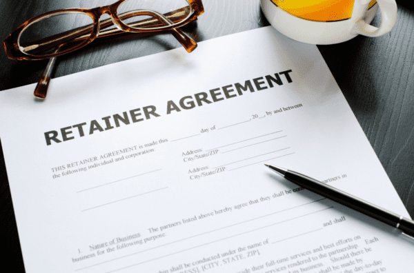 A pen and glasses sitting on top of a document.